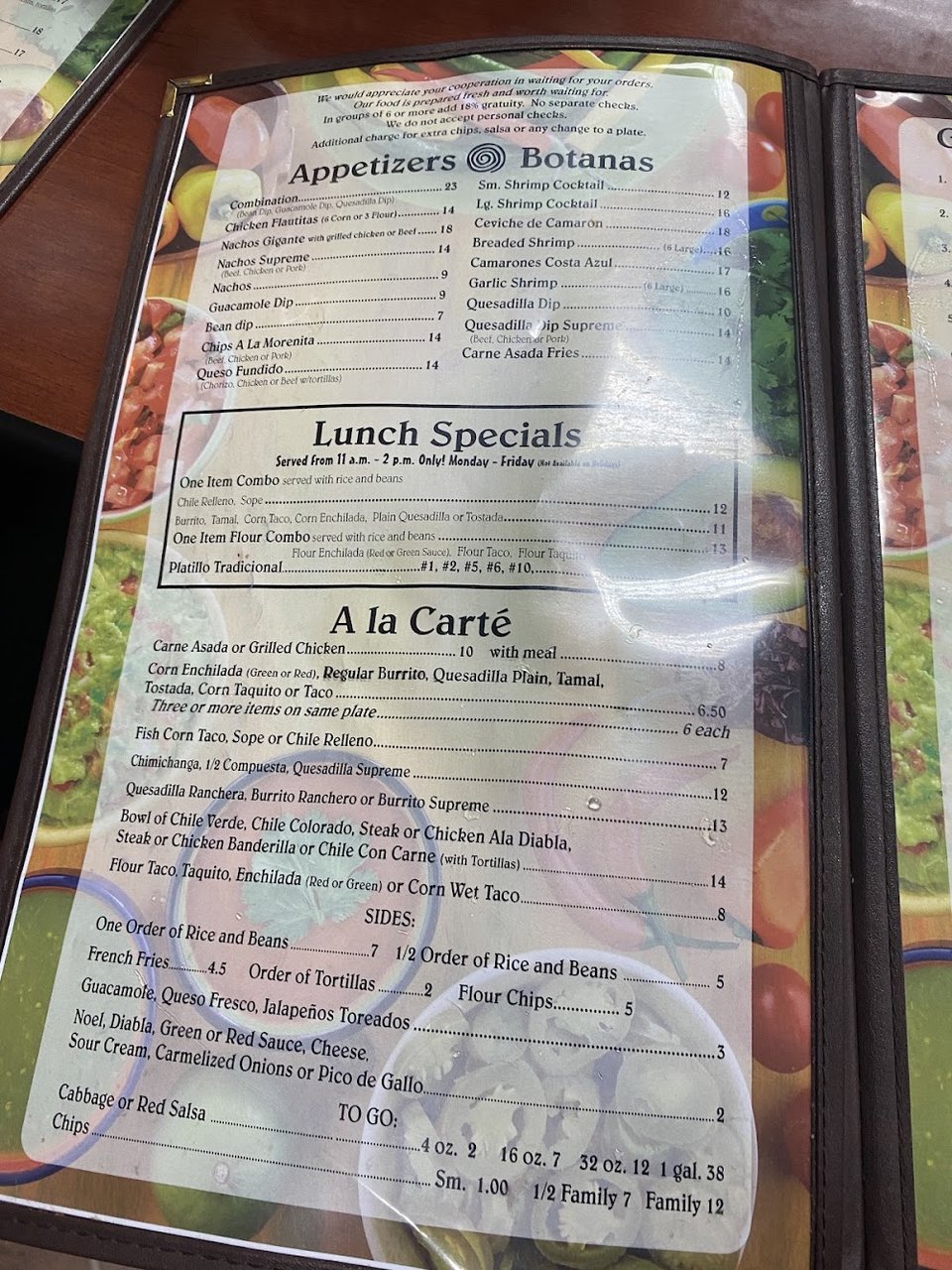 Restaurant menu featuring tacos, quesadillas, and flan.